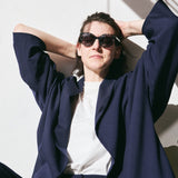 Navy hybrid suit jacket with wide kimono-inspired sleeves, arms raised - Maison Marron et amis