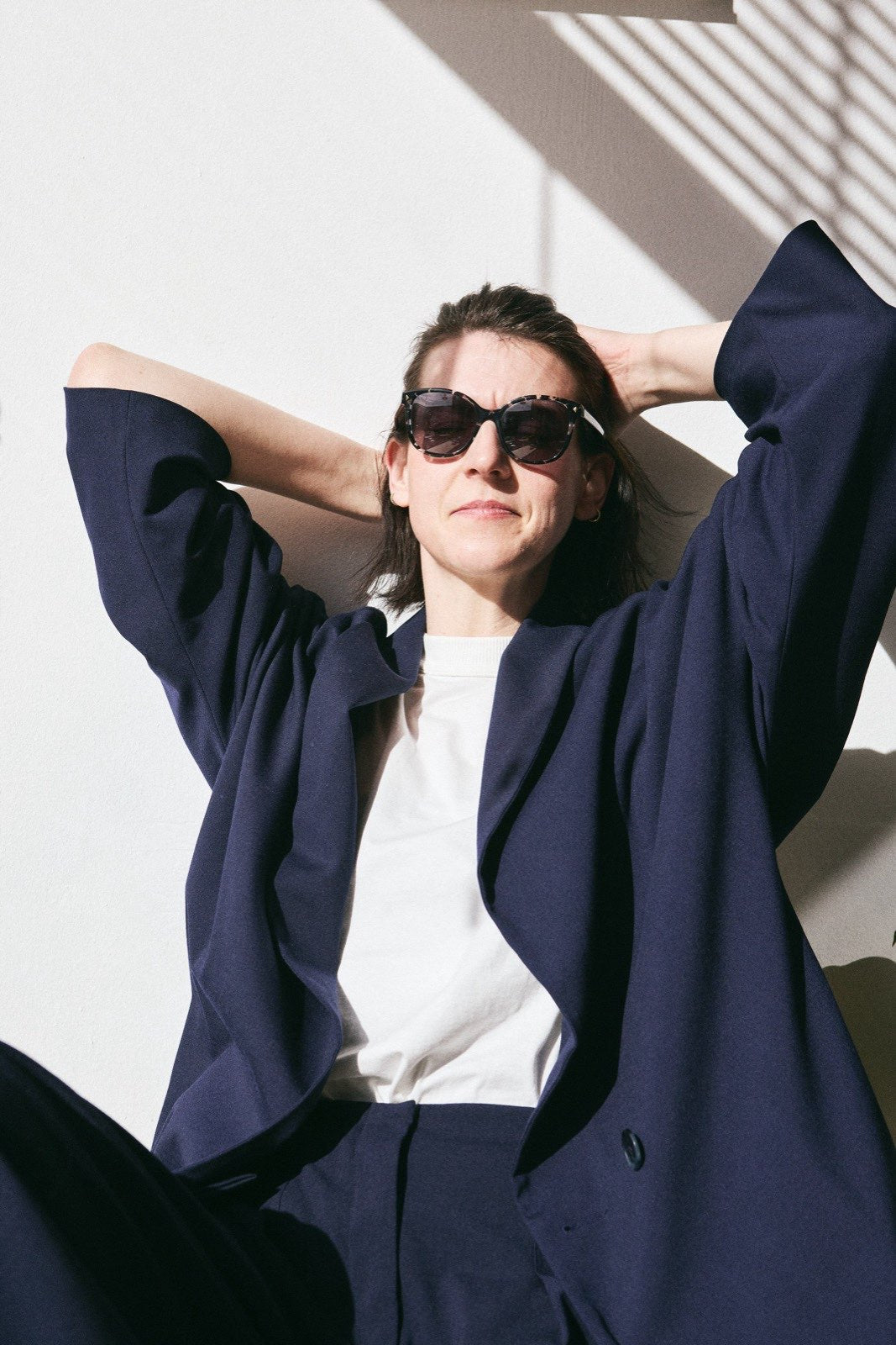 Navy hybrid suit jacket with wide kimono-inspired sleeves, arms raised - Maison Marron et amis