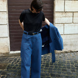 Denim n°1 Jeans in blue denim, worn with the matching Denim Shirt carried over the arm - Maison Marron et amis