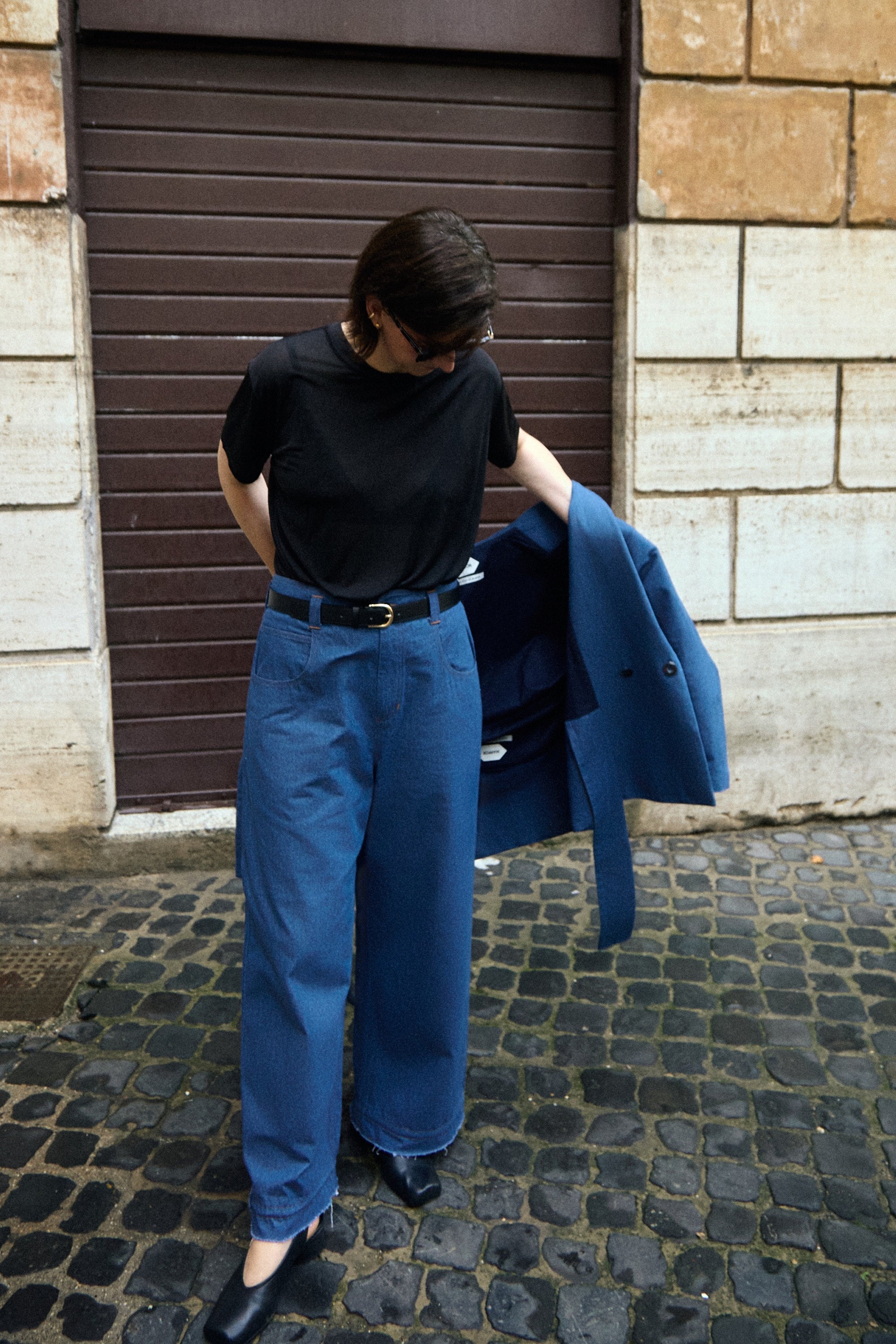 Denim n°1 Jeans in blue denim, worn with the matching Denim Shirt carried over the arm - Maison Marron et amis