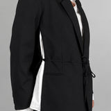Open Side Blazer in black, detail of the open side seam with the white shirt underneath - Maison Marron et amis