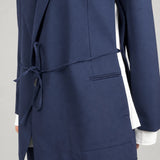 Open Side Blazer in navy, detail of the waist strap and open side seam - Maison Marron et amis